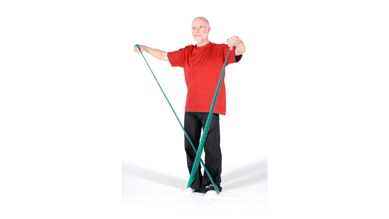 Alter Mann, rotes Shirt, schwarze Hose, steht auf Band und zieht mit beiden Händen daran