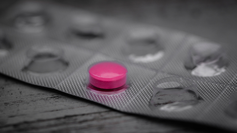 Une plaquette de comprimés de médicaments avec un seul comprimé rouge 