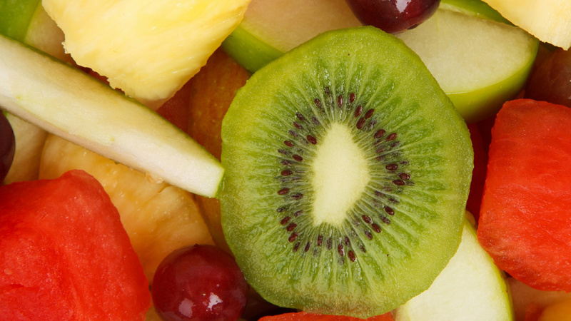 Alimentation vitamines absorption: des fruits coupés: kiwis, pommes, raisin, pastèque, ananas.